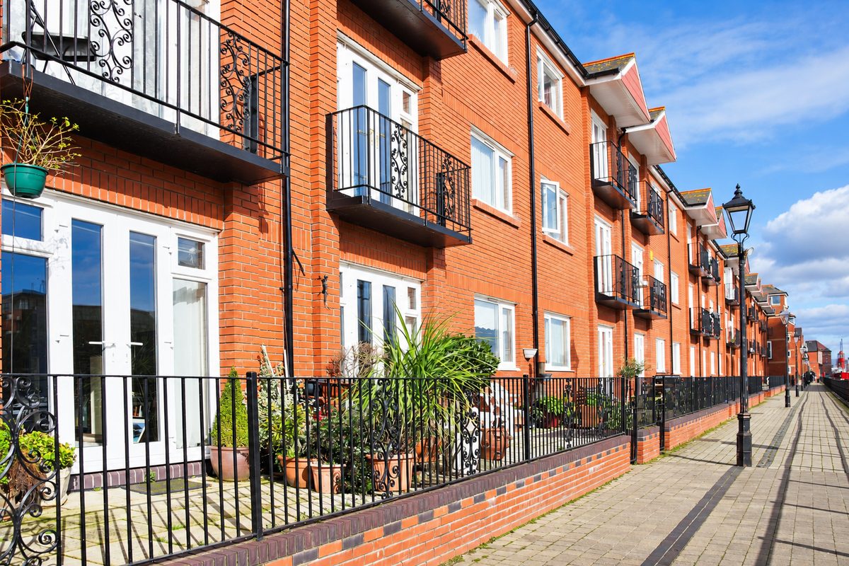 A row of brick-built flats with balconies